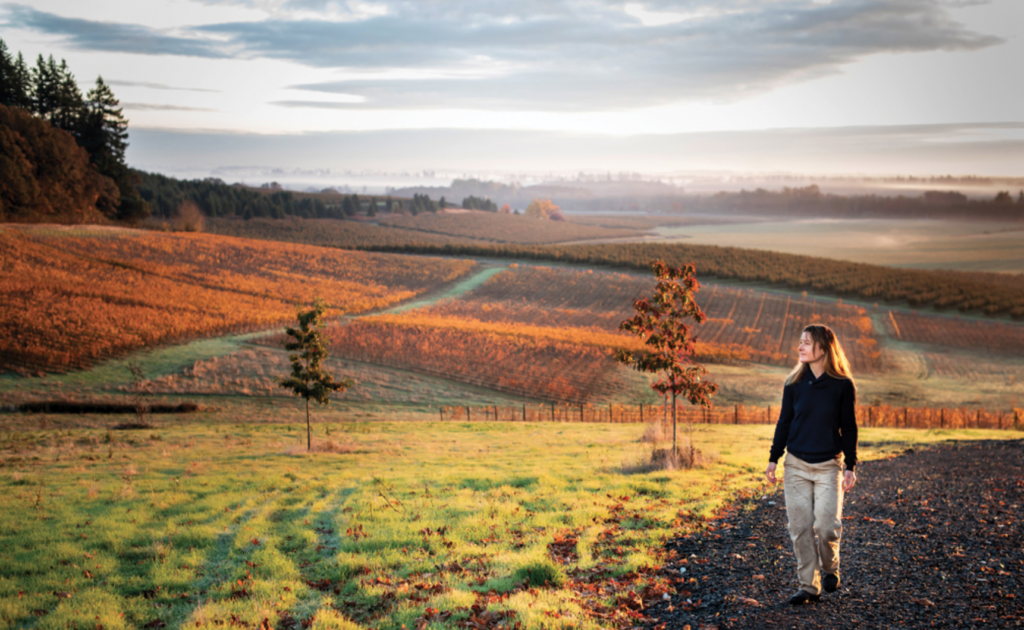 Mimi Casteel, walking among the vines at Hope Well vineyard.