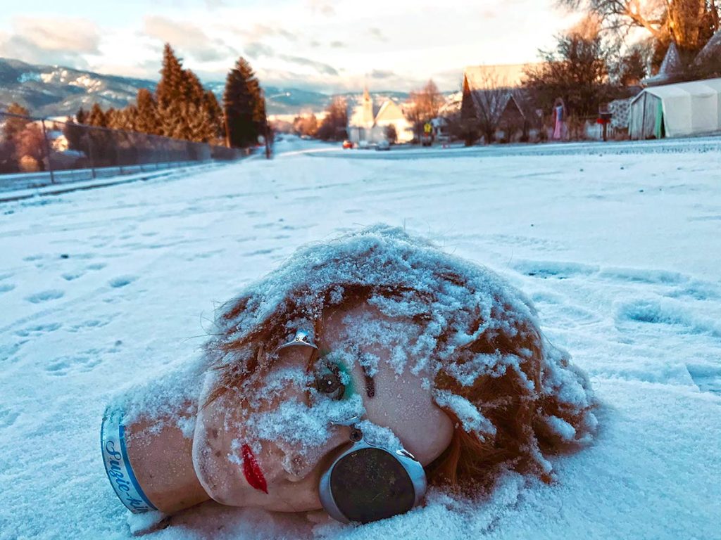 Mannequin head laying in snow.